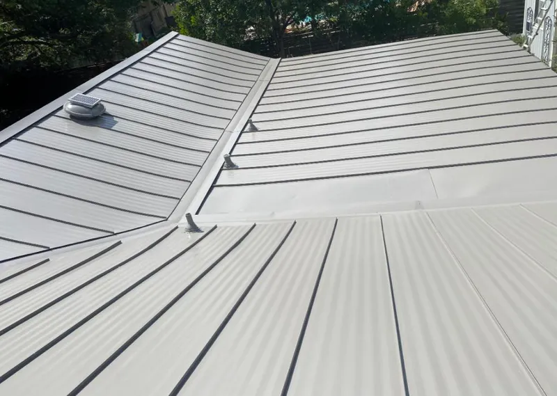 Solar attic fan installed on a metal roof for Roof Ventilation in Edgartown